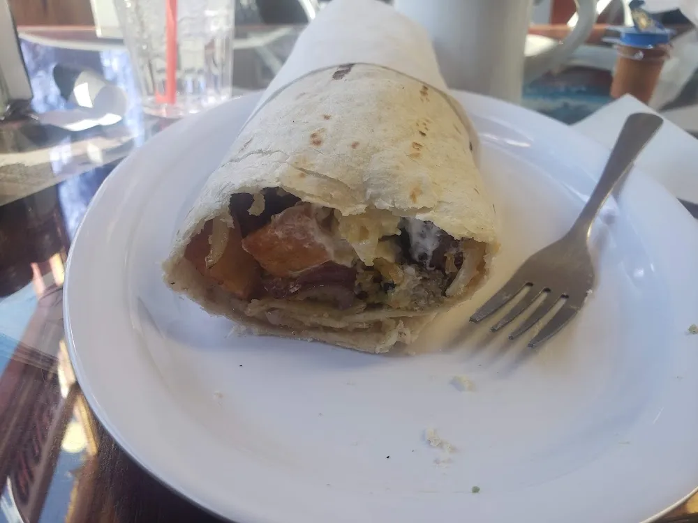 Breakfast Burrito with Sausage Avo Sour Cream Grilled Onions and Gravy